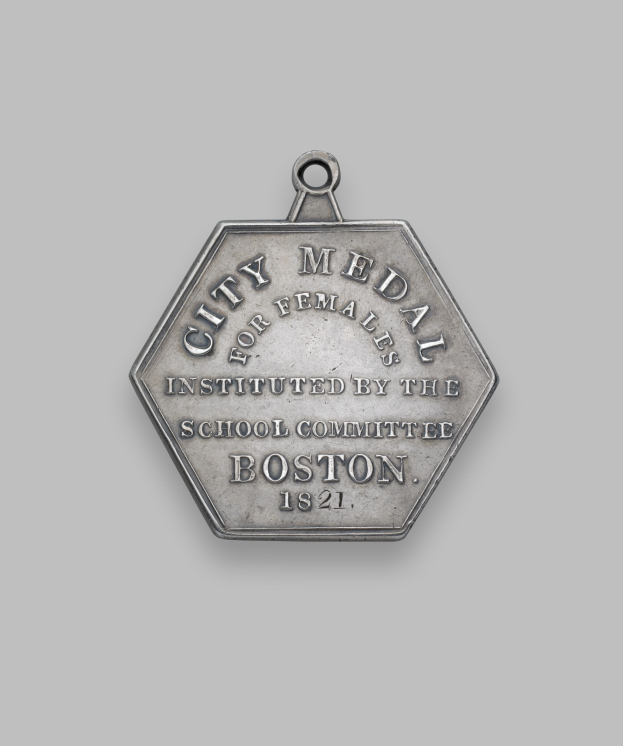 Eine Silbermedaille mit der Aufschrift "Stadtmedaille für Frauen" vor einem weißen Hintergrund.