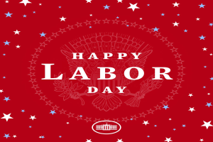 Ein Plakat mit "Happy Labor Day" in fetter weißer Schrift auf einem hellroten Hintergrund, umgeben von farbigen Sternen verschiedener Größen.