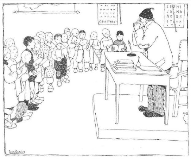 Ein Mann sitzt an einem Schreibtisch mit Büchern und Gegenständen vor einer Gruppe von Kindern, während Papiere mit Text an der Wand hinter ihm hängen.